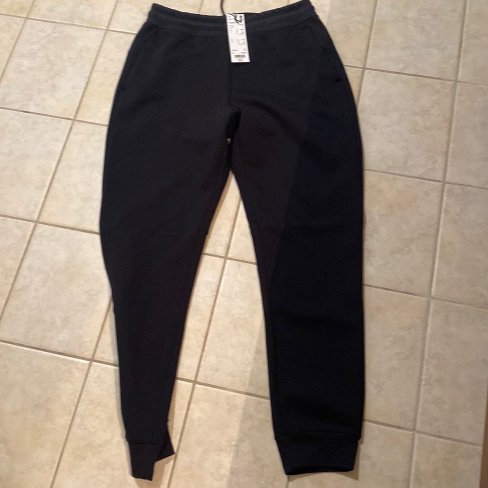 Men’s black joggers with side slit pockets. No pockets on the back . Loose cuffs